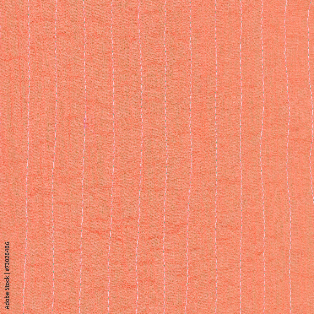 Fototapeta premium coral color textile background from stitched silk