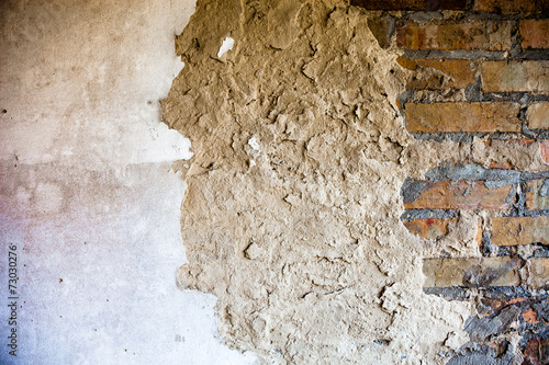 Photography Old brick wall with the damaged plaster