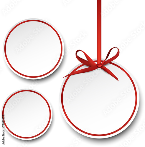 White paper gift cards with red satin bow.