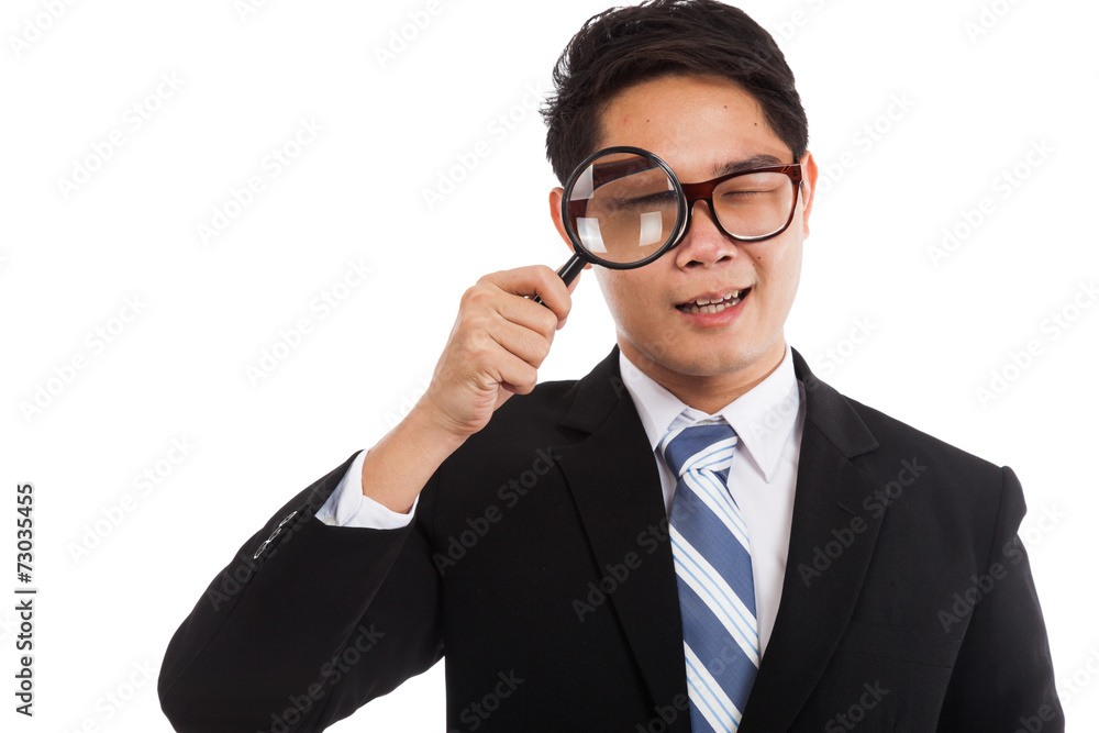 Asian businessman with  magnifying glass