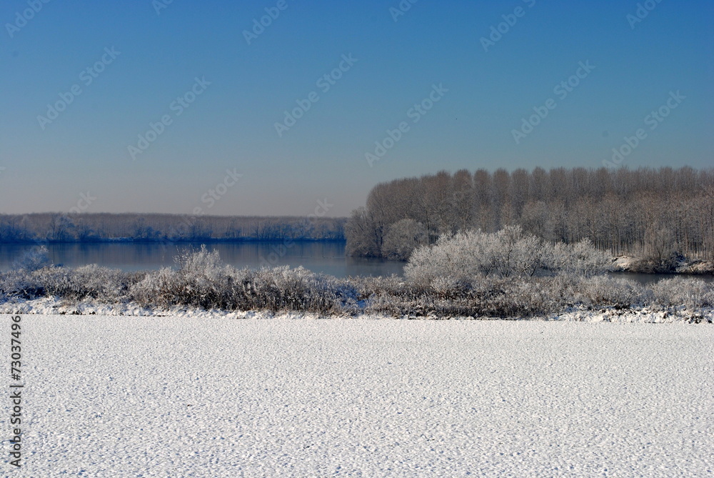 farmlands and a river covered by snow
