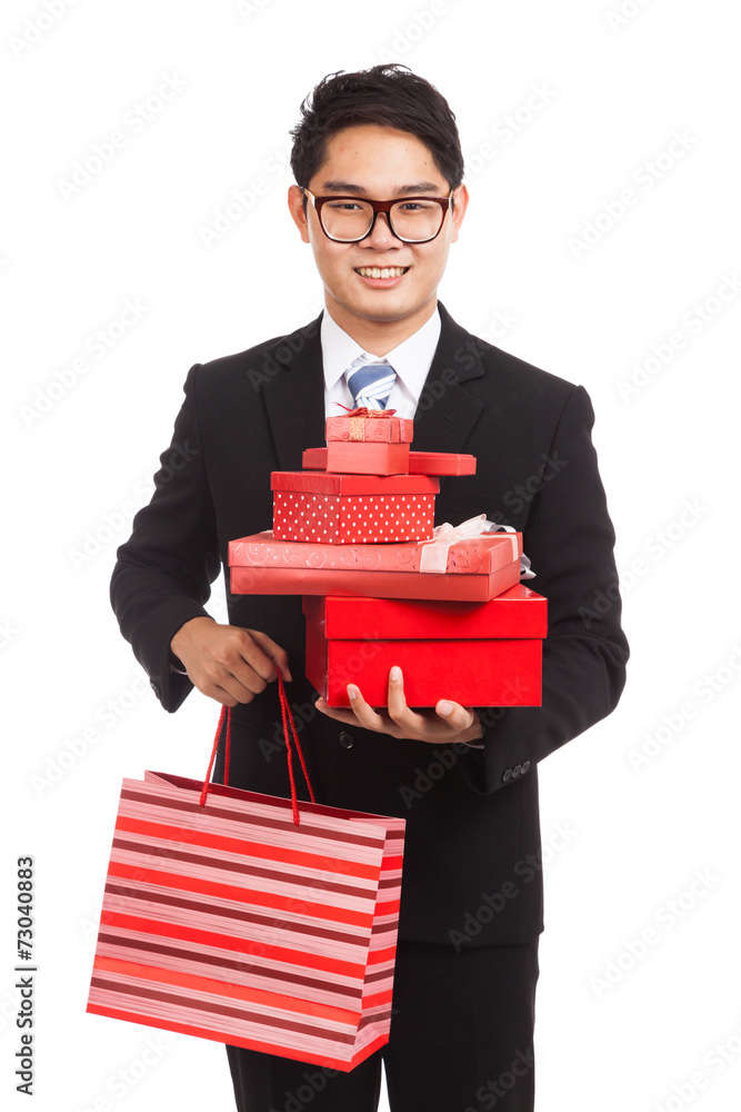 Asian businessman with many gift boxes and shopping bag Asian businessman with many gift boxes and shopping bag