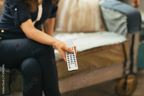 Closeup on young woman watching tv in loft apartment