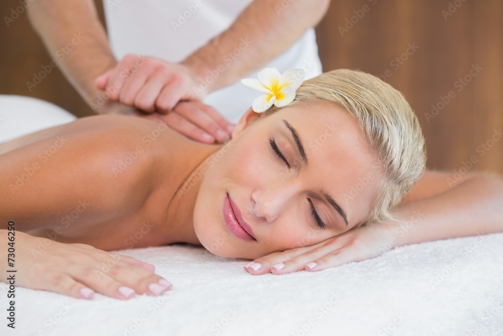 Woman receiving back massage at spa center Woman receiving back massage at spa center