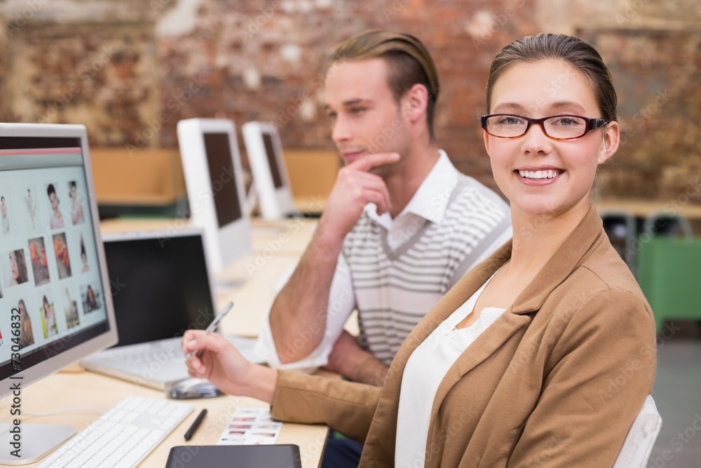 Fototapeta premium Smiling photo editors using computer in office