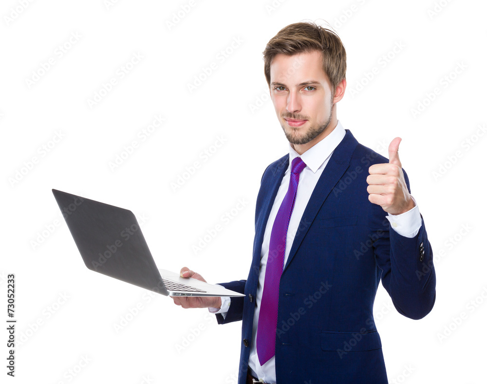 Caucasian businessman use of notebook and thumb up Caucasian businessman use of notebook and thumb up