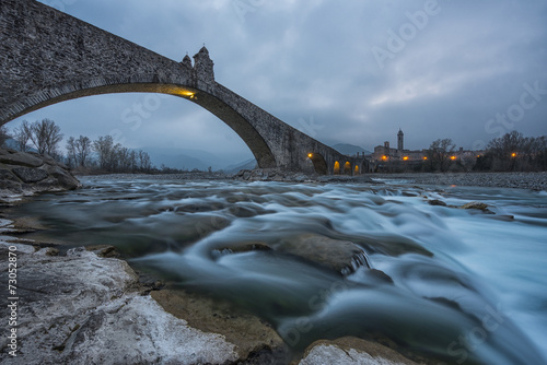 The old town of Bobbio and the bridge Gobbo by night, Italy