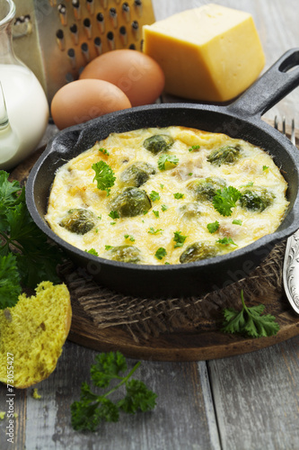 Casserole with brussels sprouts and cheese in a frying pan