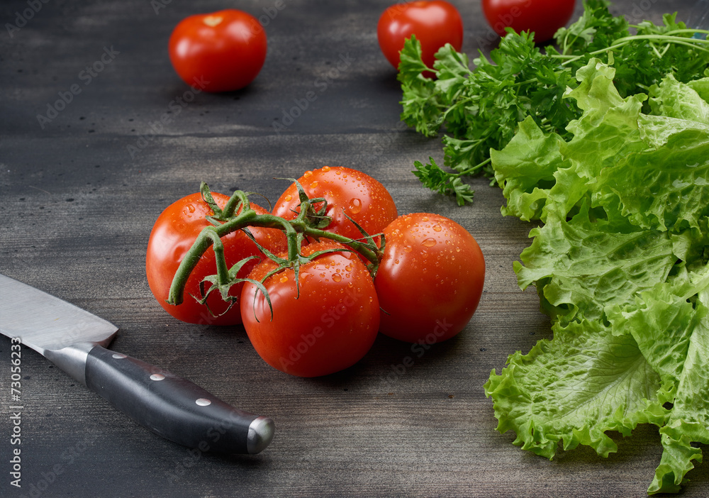Kitchen knife in table with vegetables