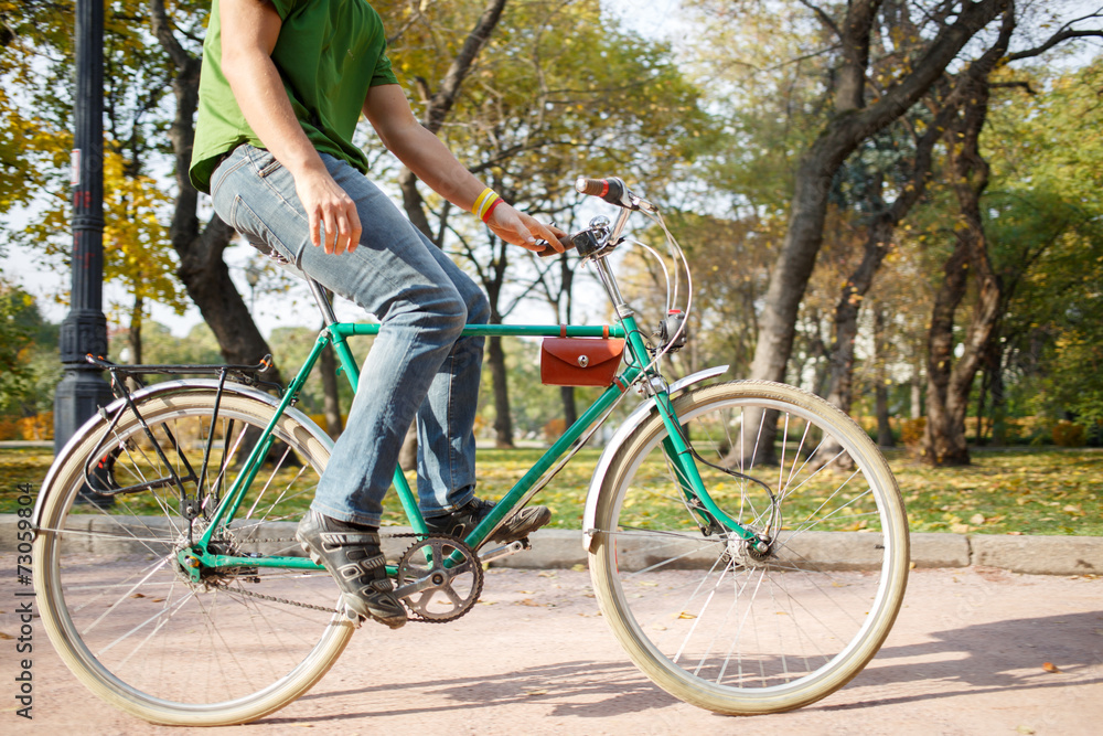 Fototapeta premium Close-up of young man riding bicycle in park