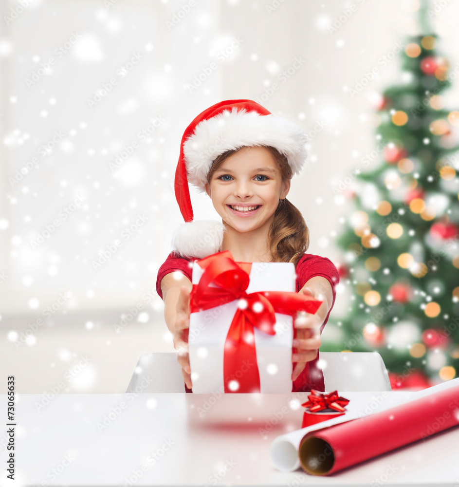 smiling girl in santa helper hat with gift box smiling girl in santa helper hat with gift box