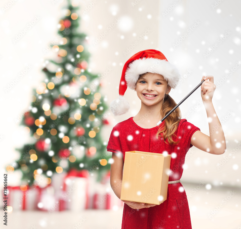 smiling girl in santa helper hat with gift box smiling girl in santa helper hat with gift box