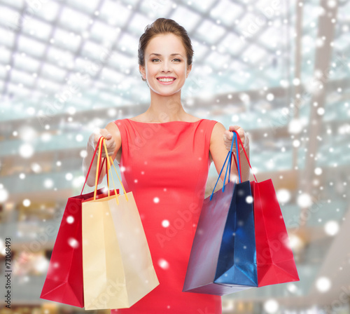 smiling woman with colorful shopping bags