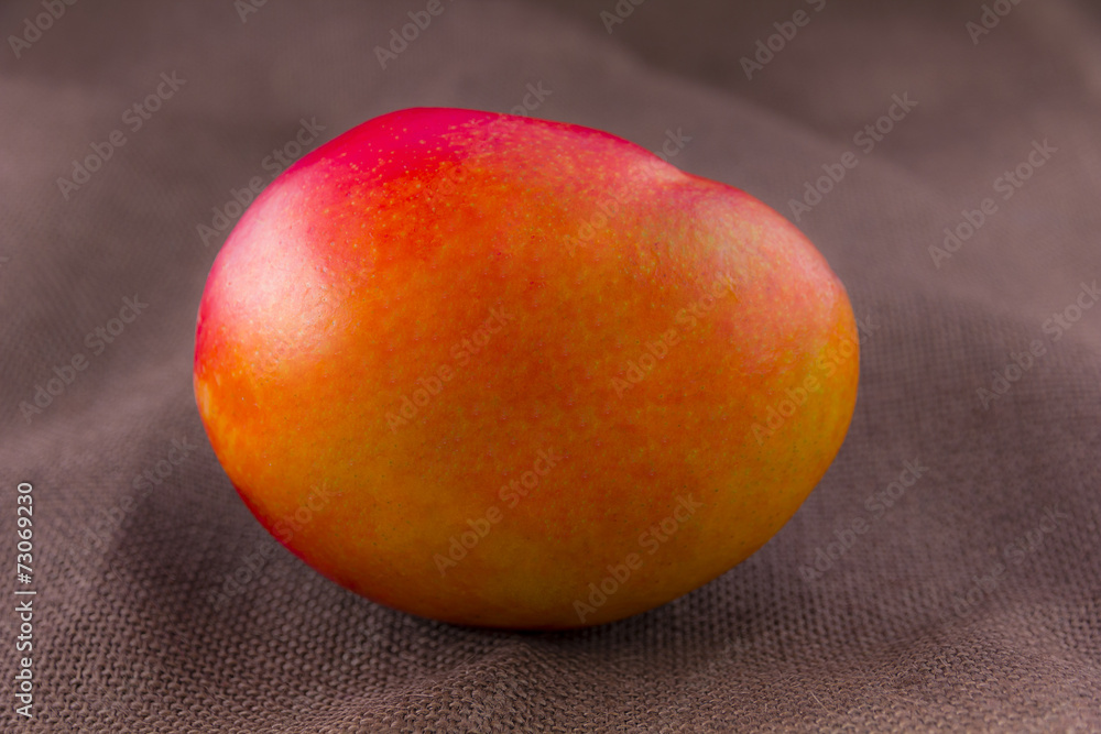 Mango fruit isolated on brown background Mango fruit isolated on brown background