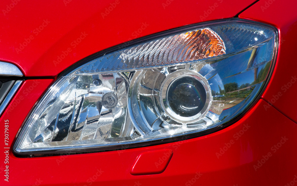 Headlamp on red car
