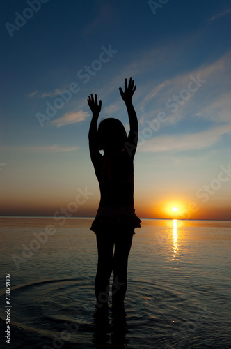 Child silhouette on sunset beach  summer sea vacation