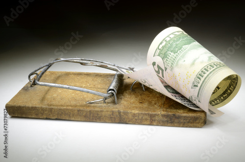 Dollar banknote in mousetrap