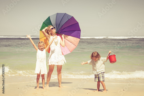 Happy family playing on the beach