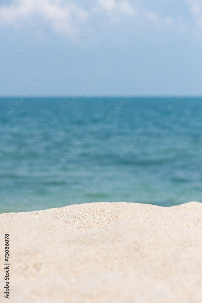 Sandy beach with horizon over blue sea background