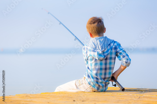 Boy in blue shirt sit on a pie