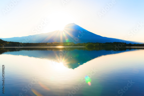 Sunshine and inverted Mount Fuji reflected in Lake Tanukiko
