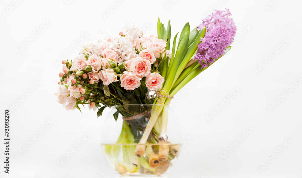 colorful flowers in glass vase against white background