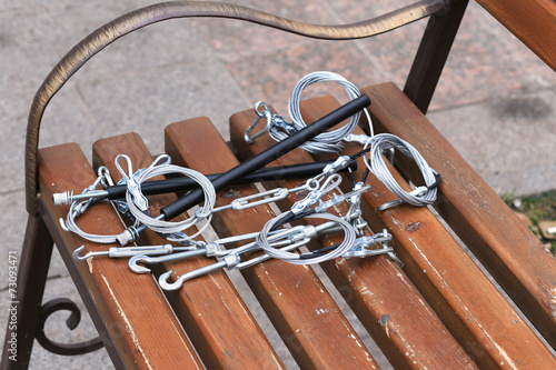 Hooks, fastening, rope lying on a wooden bench