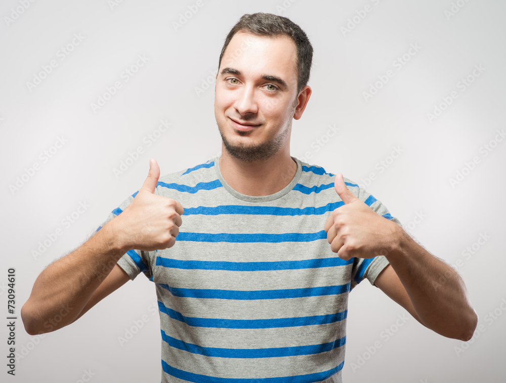 Handsome man holds his thumbs up Handsome man holds his thumbs up