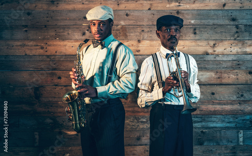 Two african american jazz musicians with trumpet and saxophone s photo