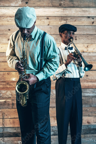 Photography Two african american jazz musicians playing trumpet and saxophon