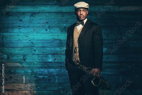 Photography Vintage african american jazz musician with saxophone in front o