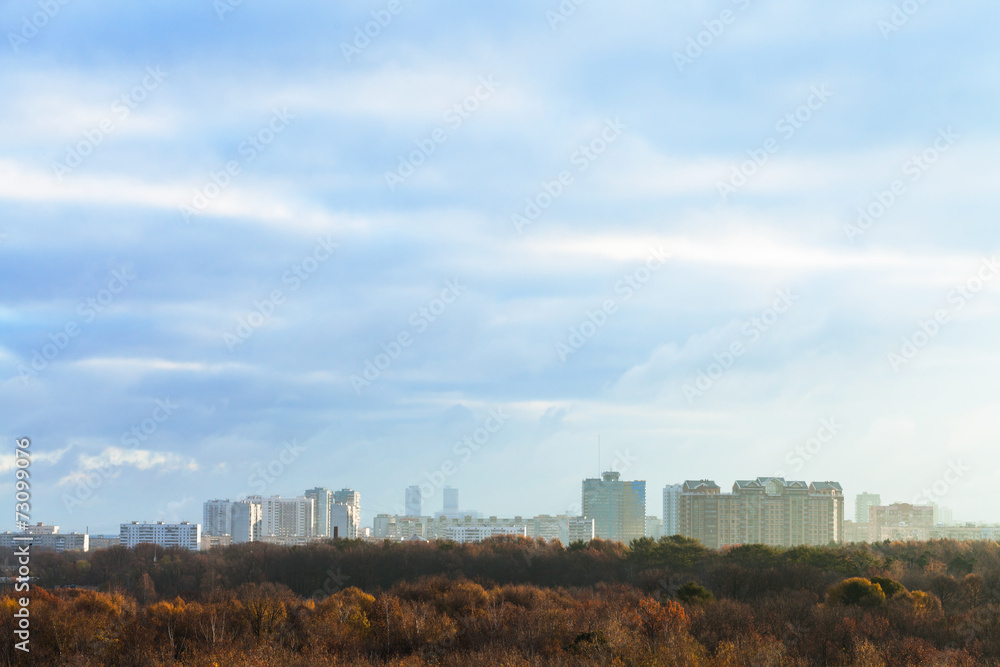 evening blue clouds over city in autumn