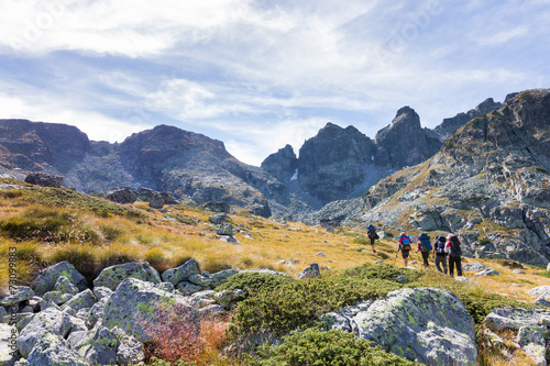 Group backpackers walking mountains. Rila range, Bulgaria.