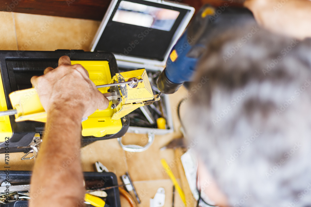Man making hole with electric drill Man making hole with electric drill