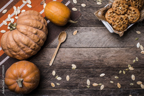 Pumpkins and cookies on wood in Rustic style