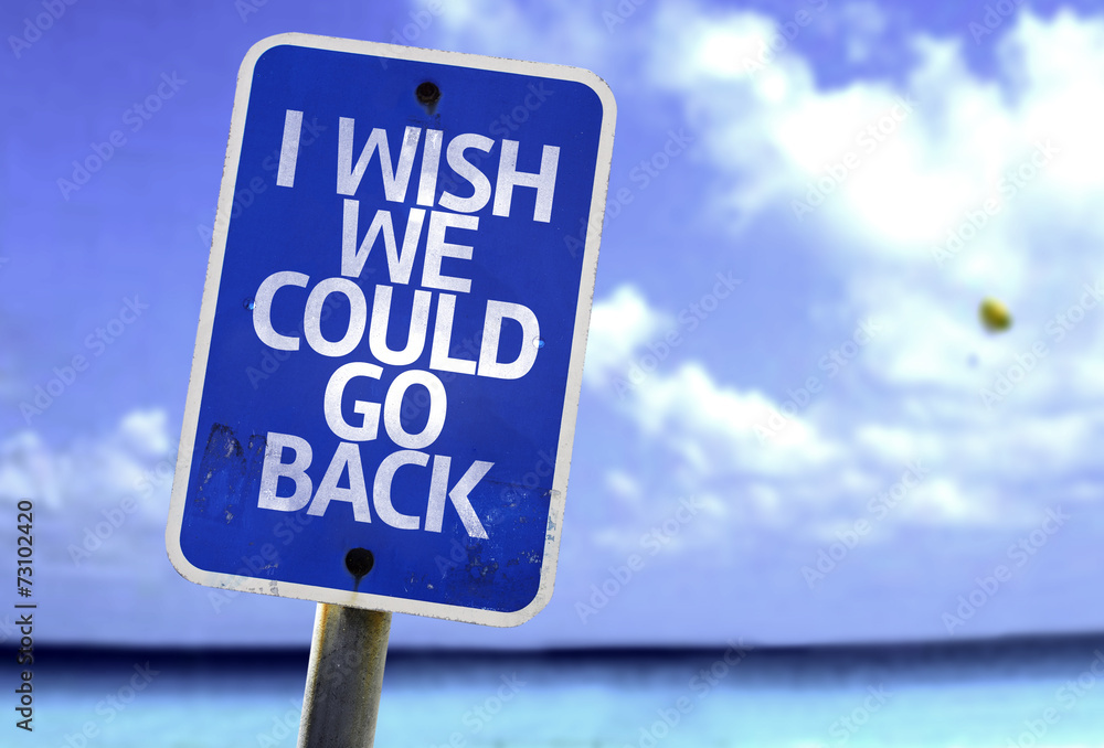 I Wish We Could Go Back sign with a beach on background