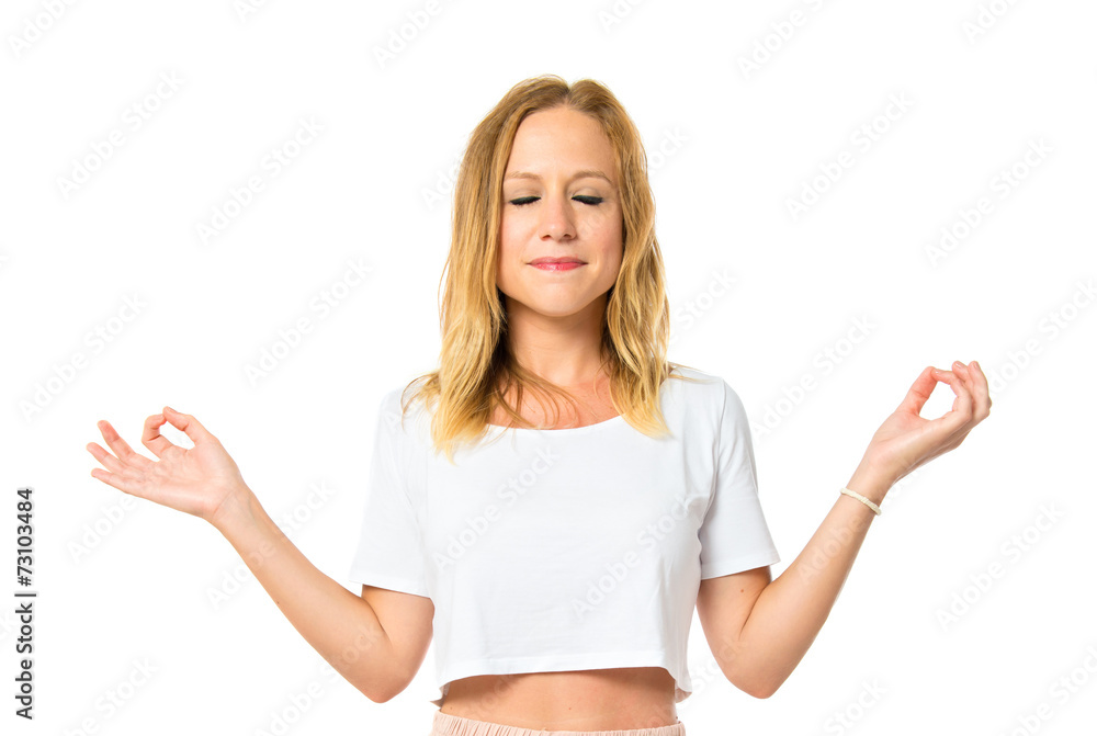 Blonde girl in zen position over white background Blonde girl in zen position over white background