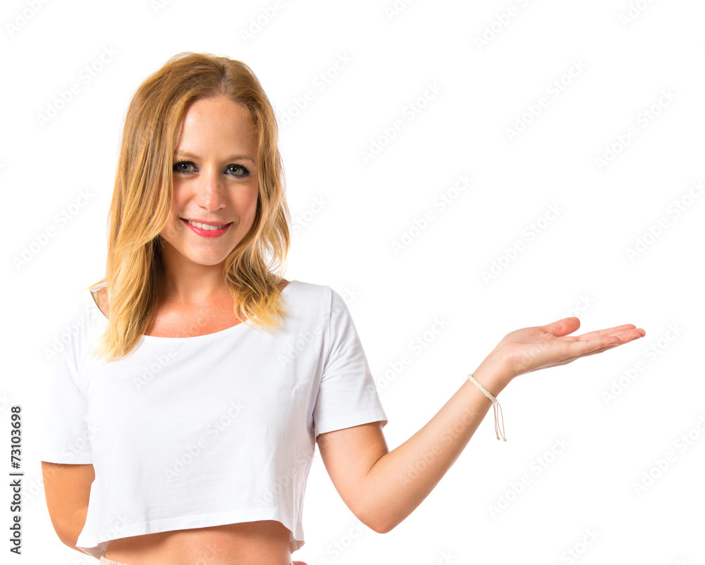 Girl holding something over white background Girl holding something over white background
