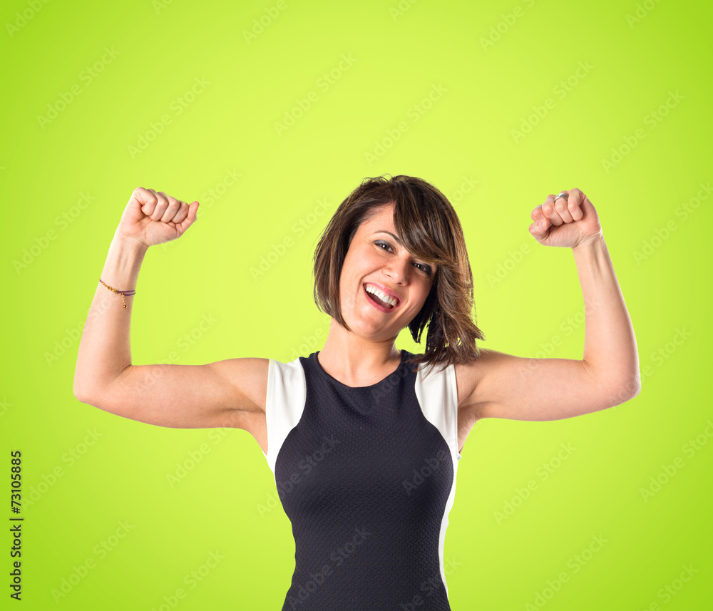 Lucky woman over isolated green background Lucky woman over isolated green background