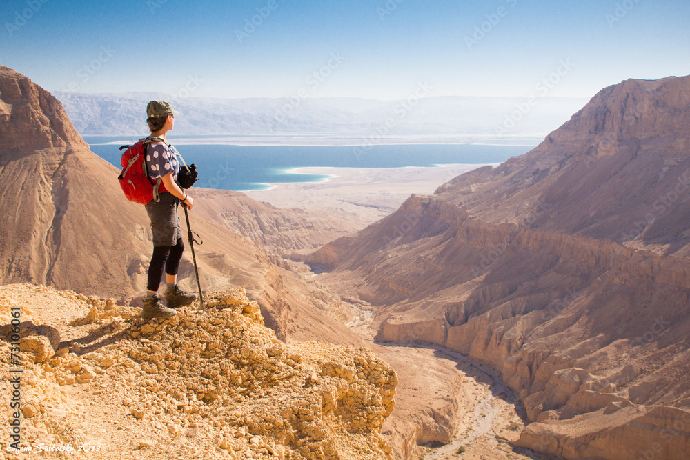 Backpacker woman standing desert mountain edge. Backpacker woman standing desert mountain edge.