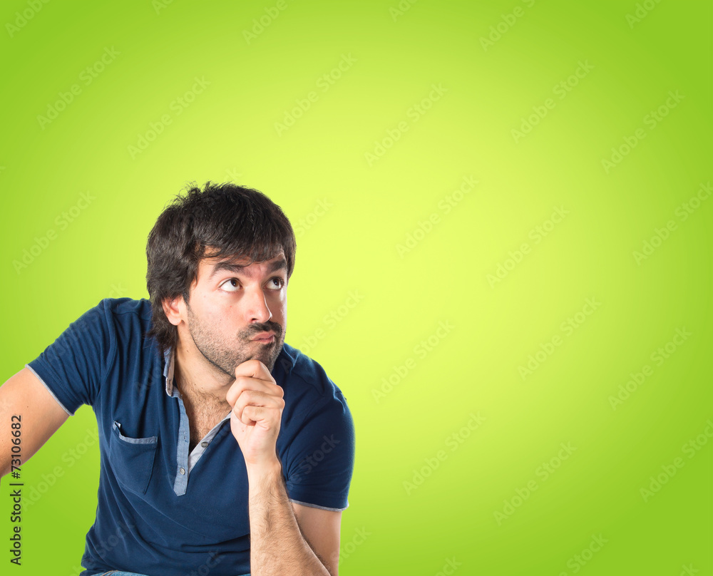 Man thinking over green background Man thinking over green background