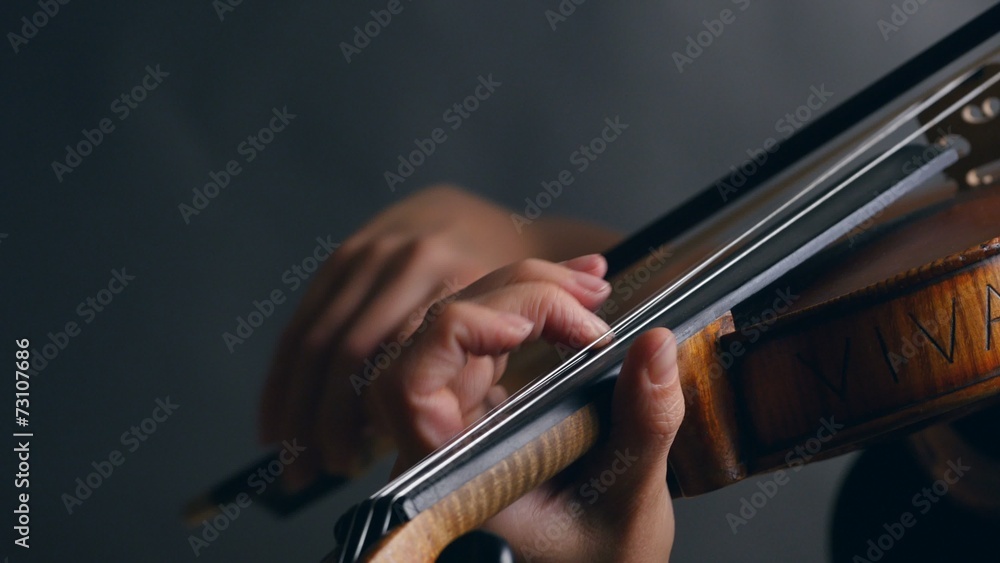 Woman playing violin over dark background. UHD, 4K Woman playing violin over dark background. UHD, 4K