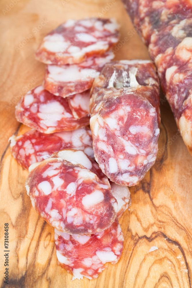 sliced dried smoked sausage on chopping wood board sliced dried smoked sausage on chopping wood board