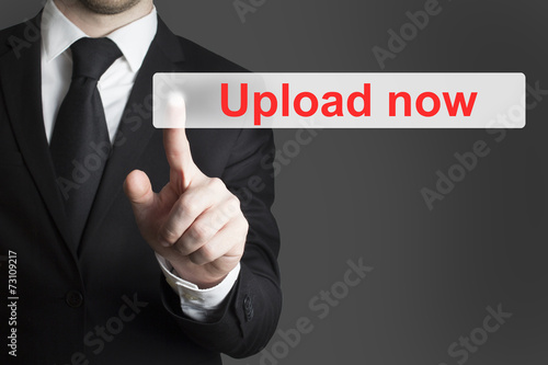 businessman pushing flat button upload now