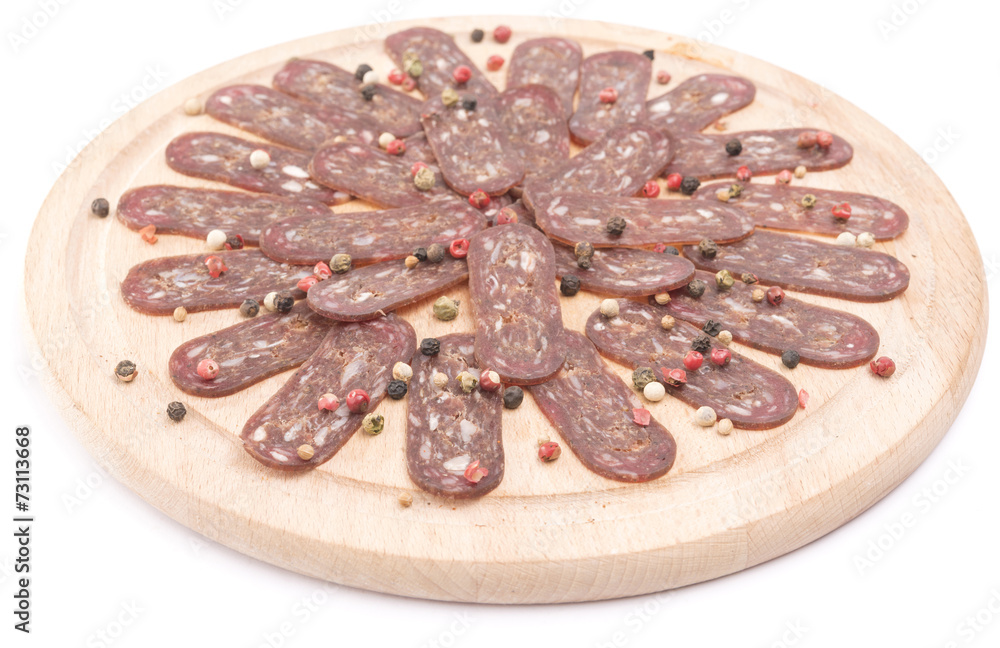 Obraz premium flat sausage on rounder wooden board isolated