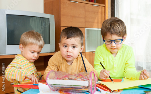 children drawing at  table.