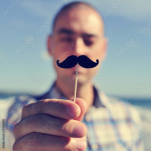 Obraz na plátně young man with a fake moustache
