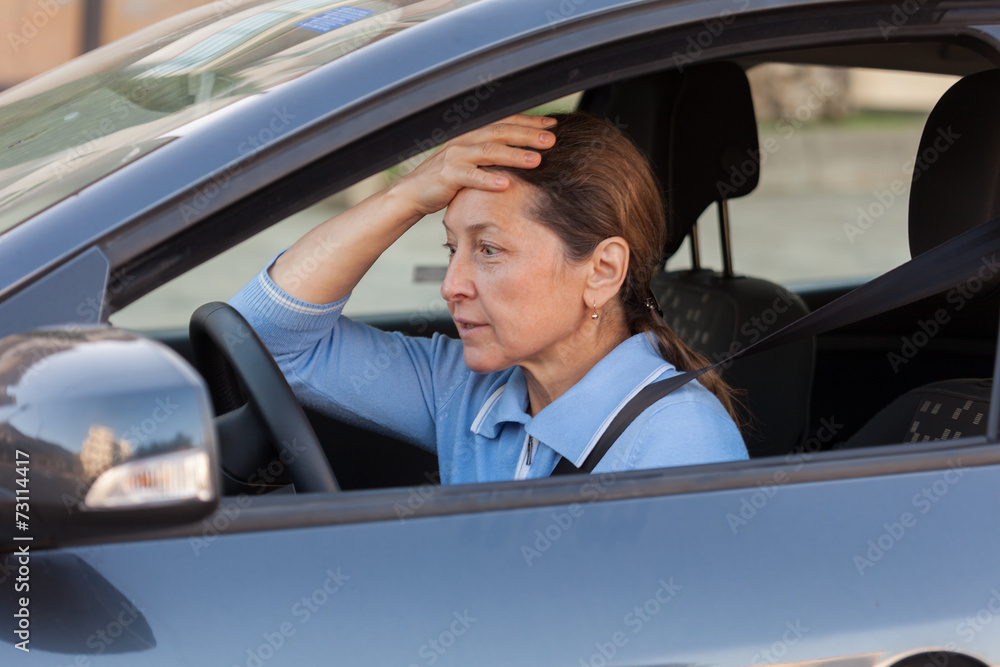 frightened mature woman in car. frightened mature woman in car.