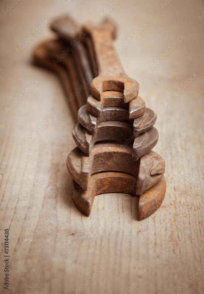 old wrenches on a wooden background 6 old wrenches on a wooden background 6