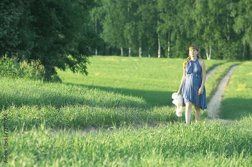 girl walking along the road in a field alone © kichigin19